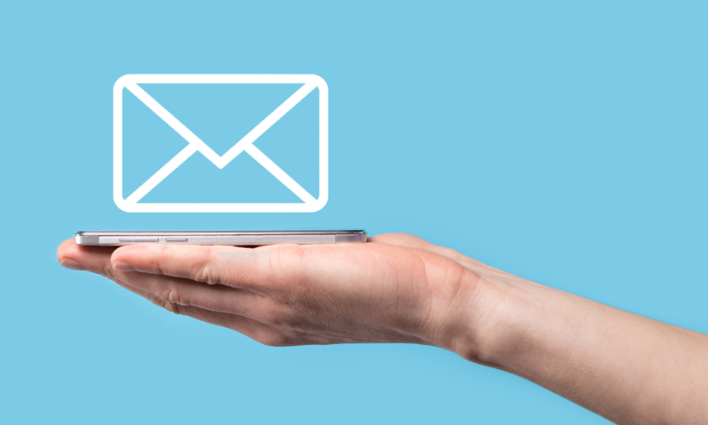 Hand holding email icon