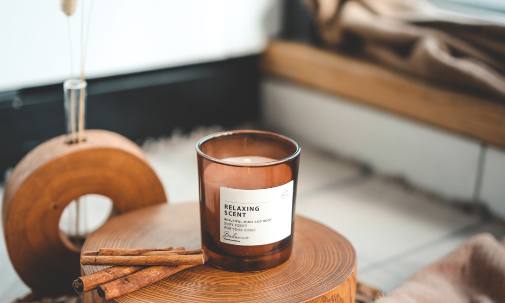 Autumn marketing image of a coffee table with a Relaxing Scent candle on a tree stump