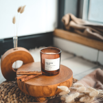 Autumn marketing image of a coffee table with a Relaxing Scent candle on a tree stump