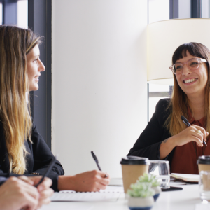 PR agency meeting between 2 women at a table