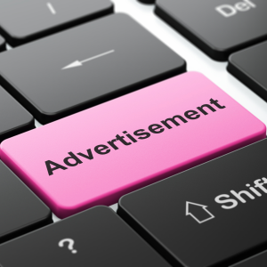 Pink key on keyboard reading Advertisement