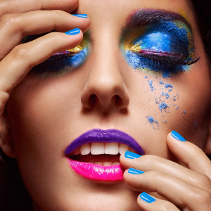 Close up of woman with blue editorial makeup