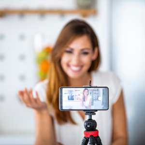 Social media influencer speaking to phone camera on tripod