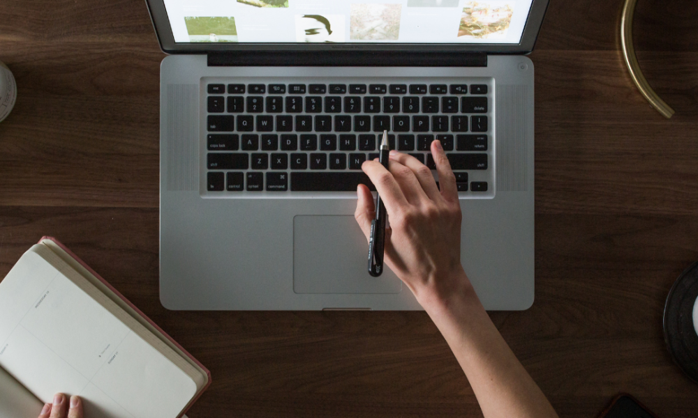 Top down view of using a laptop for GEO and SEO